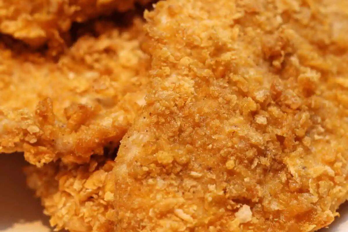 Close-up of crispy golden-brown fried chicken, showcasing a textured and crunchy coating that's perfect for two—a delicious dinner idea.