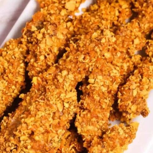 Several crispy, golden-brown breaded chicken tenders are arranged on a white plate—perfect for busy weeknights or when you’re seeking quick alternatives to traditional cube steak recipes.