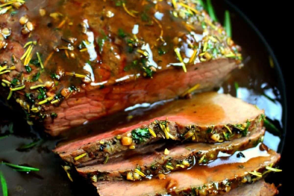 Garlic Herb Roast Beef, featuring a tender roast infused with garlic and aromatic herbs.