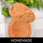 A spoonful of meatloaf seasoning is held above a bowl, promising a flavorful homemade touch. Green herbs blur softly in the background. The text "Homemade Meatloaf Seasoning" graces the bottom, inviting you to enhance your culinary creations with this savory blend.