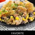 A serving of Chicken Tater Tot Casserole with corn, black beans, and golden tater tots on top, served on a black plate. Text reads "Favorite Mexican Chicken Tater Tot Casserole.