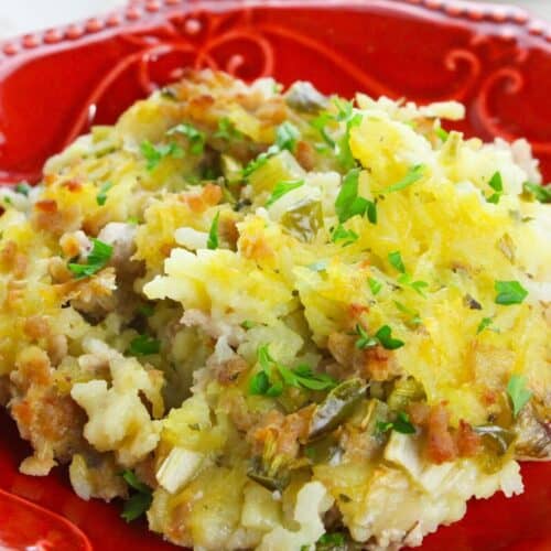 A red plate with the sausage with rice casserole.