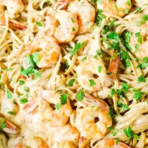 A skillet filled with spaghetti, shrimp, and creamy sauce, garnished with chopped parsley—one of those easy recipes perfect to spoil mom with on Mother’s Day.
