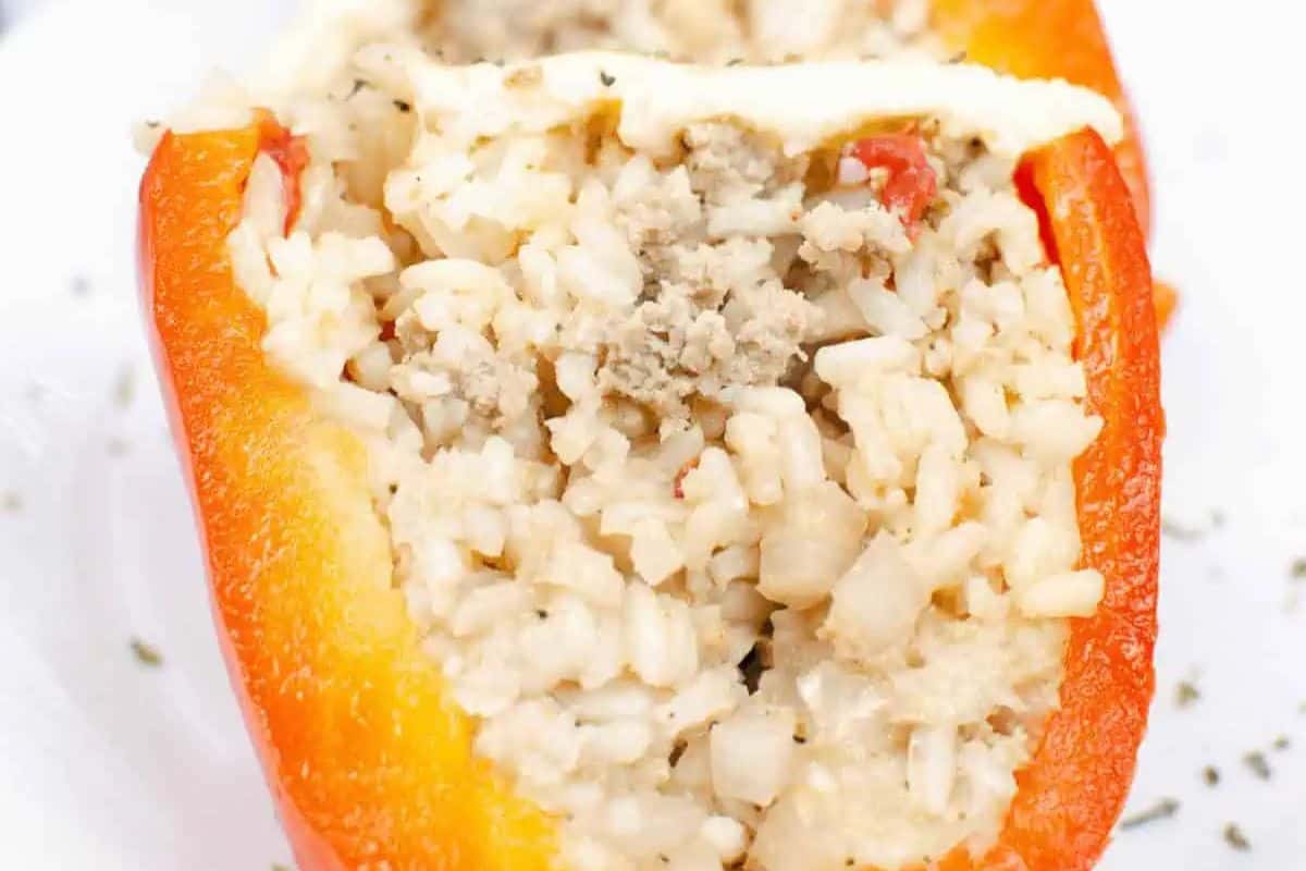 A halved red bell pepper stuffed with a mixture of rice, ground meat, and small diced vegetables, topped with a light sprinkle of herbs—this is one of those game changing Instant Pot recipes you'll want to repeat again and again.