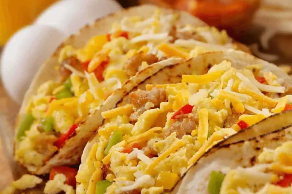 Fluffy scrambled eggs, seasoned sausage, and colorful diced bell peppers are loaded into warm tortillas and topped with a generous handful of shredded cheese. These breakfast tacos are hearty, flavorful, and perfect for starting the day right.