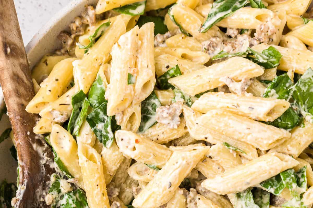 ender penne pasta is coated in a rich, creamy sauce and tossed with crumbled sausage and fresh spinach. This dish is indulgent, comforting, and packed with flavor in every bite.