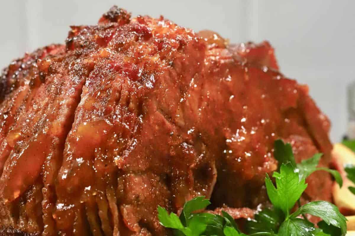 Fresh off the smoker, this ham has a golden, smoky crust that’s deeply browned and incredibly inviting. The layers are juicy and tender, with a subtle char that hints at its slow-cooked perfection. It’s a great visual for smoky holiday flavor.