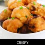 A bowl of crispy, golden-brown Air Fryer Cauliflower Wings is garnished with chopped green onions, showcasing the perfect appetizer for guilt-free snacking.