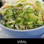 A blue bowl filled with California Roll Cucumber Salad—crisp cucumbers, imitation crab, and green onions. Text overlay reads: "Viral California Roll Cucumber Salad.