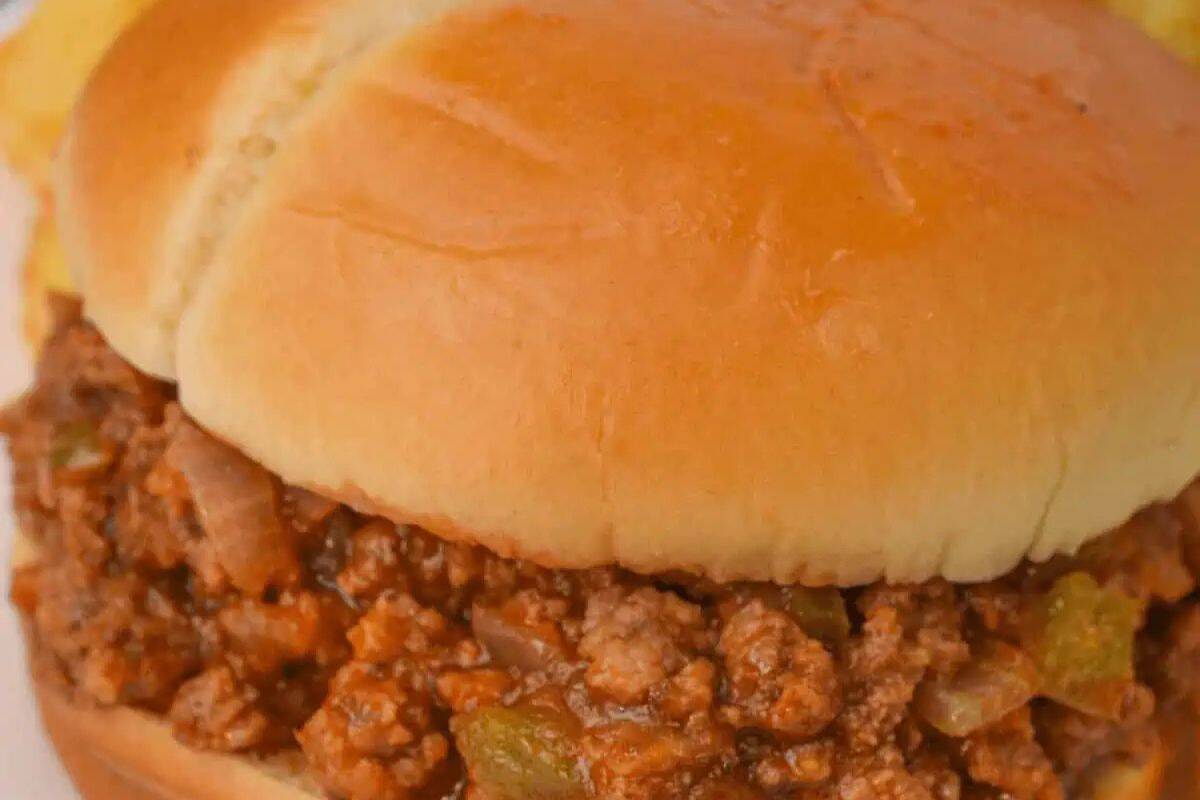 Close-up of a sloppy joe sandwich with seasoned ground meat, onions, and green peppers in a soft hamburger bun—a classic favorite from Star Spangled BBQ’s American recipes.