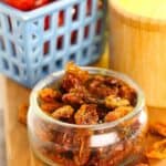A glass dish of the dried tomatoes in the oven.
