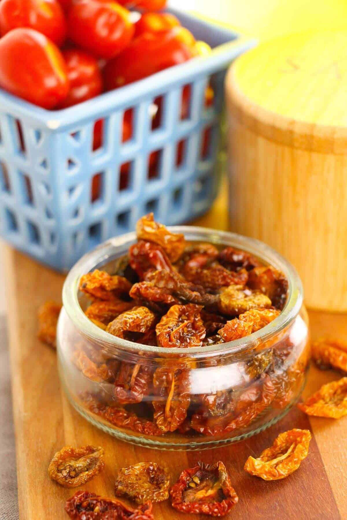 A glass dish of the dried tomatoes in the oven.