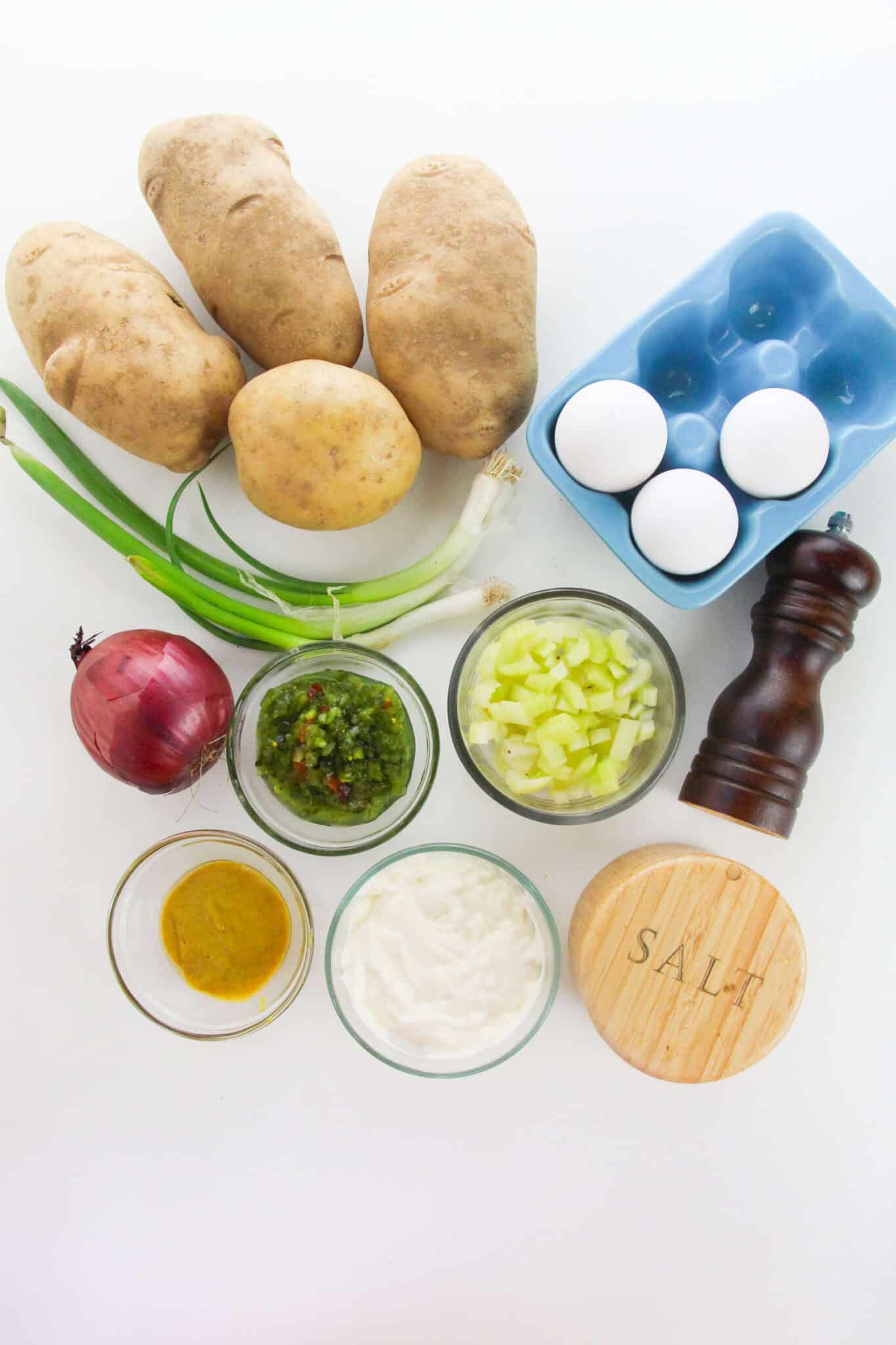 Potatoes, onions, eggs, mayo and the seasoning for the dish.
