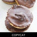 Three homemade peanut butter cups stacked on a white surface, with a label reading "Copycat Homemade Reese's Peanut Butter Cups.