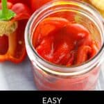 Open jar of Roasted Red Bell Peppers with fresh red bell peppers and a yellow item in the background. Text reads: "Easy Homemade Roasted Red Bell Peppers.