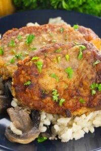 Pan fried boneless pork chops on a bed of rice.