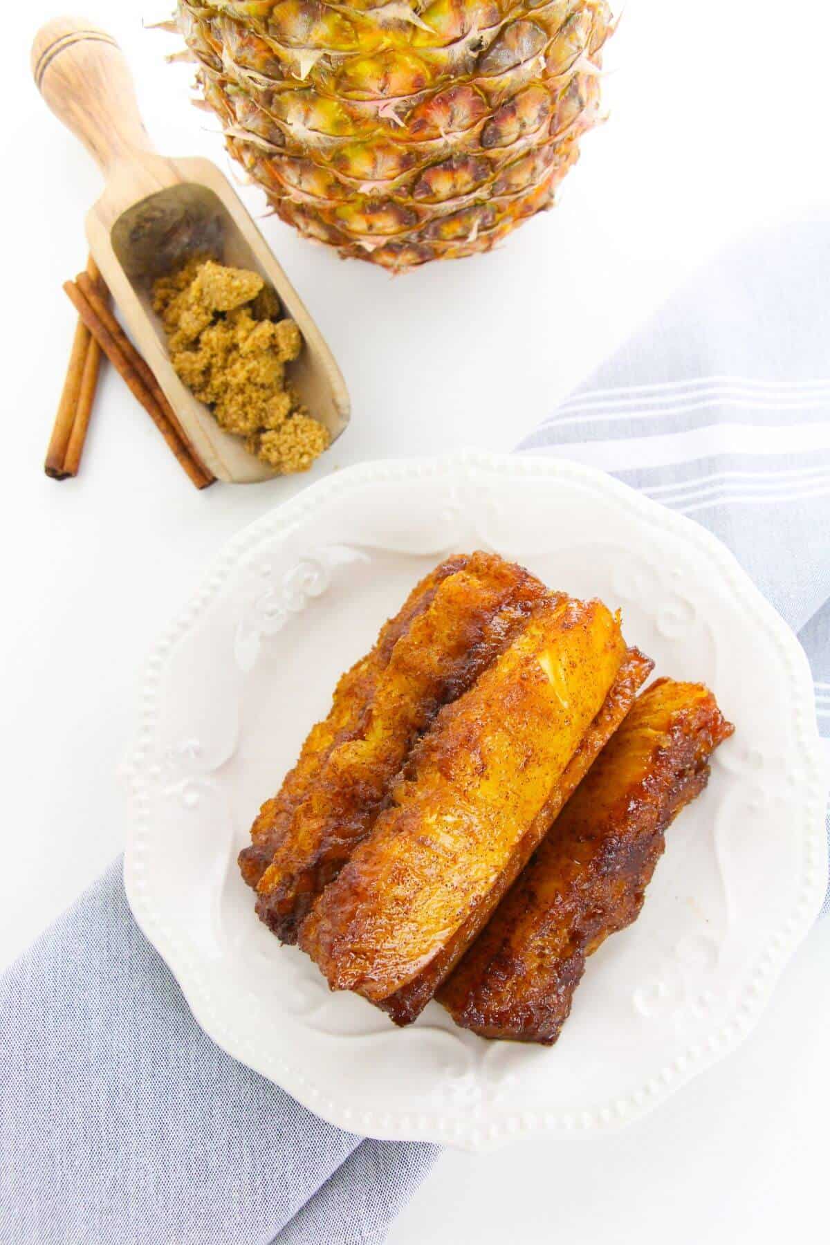 A white plate with caramelized pineapple.