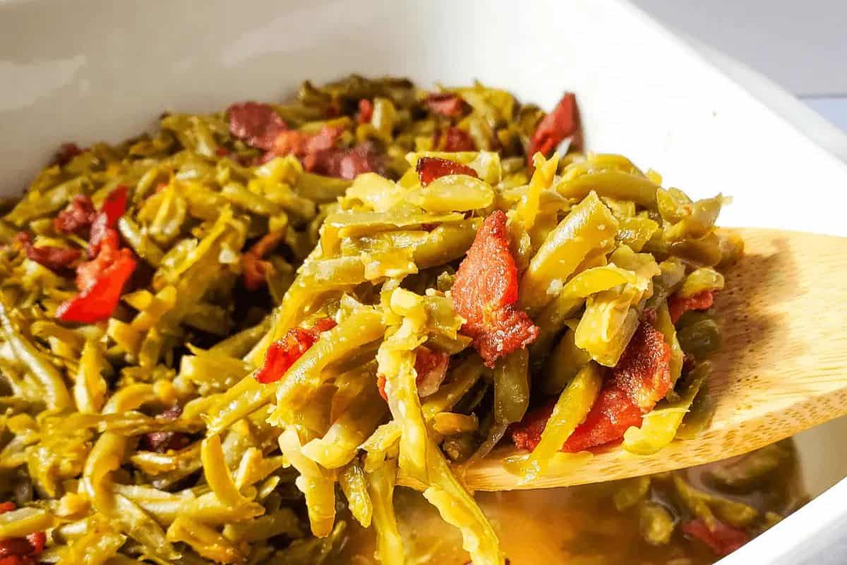 Tender green beans are smothered in a rich glaze and mixed with savory bacon pieces in this hearty side dish. The smoky flavor of the bacon pairs perfectly with the slightly sweet sauce, creating an irresistible combination. Comfort food at its finest.