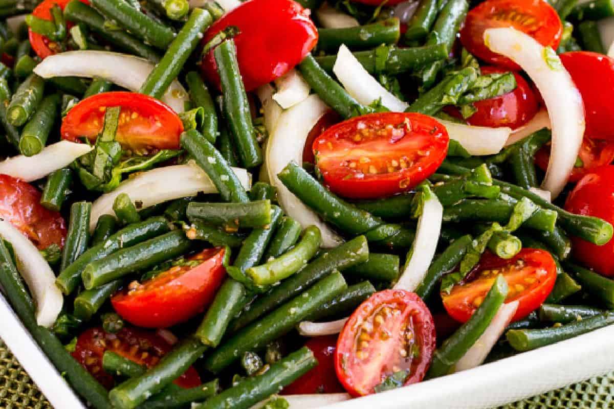 This colorful salad is loaded with bright green beans, juicy cherry tomatoes, slivers of onion, and ribbons of fresh basil. A light vinaigrette ties all the ingredients together in a refreshing and tangy blend. It’s a beautiful, garden-fresh dish that’s perfect for summer meals.