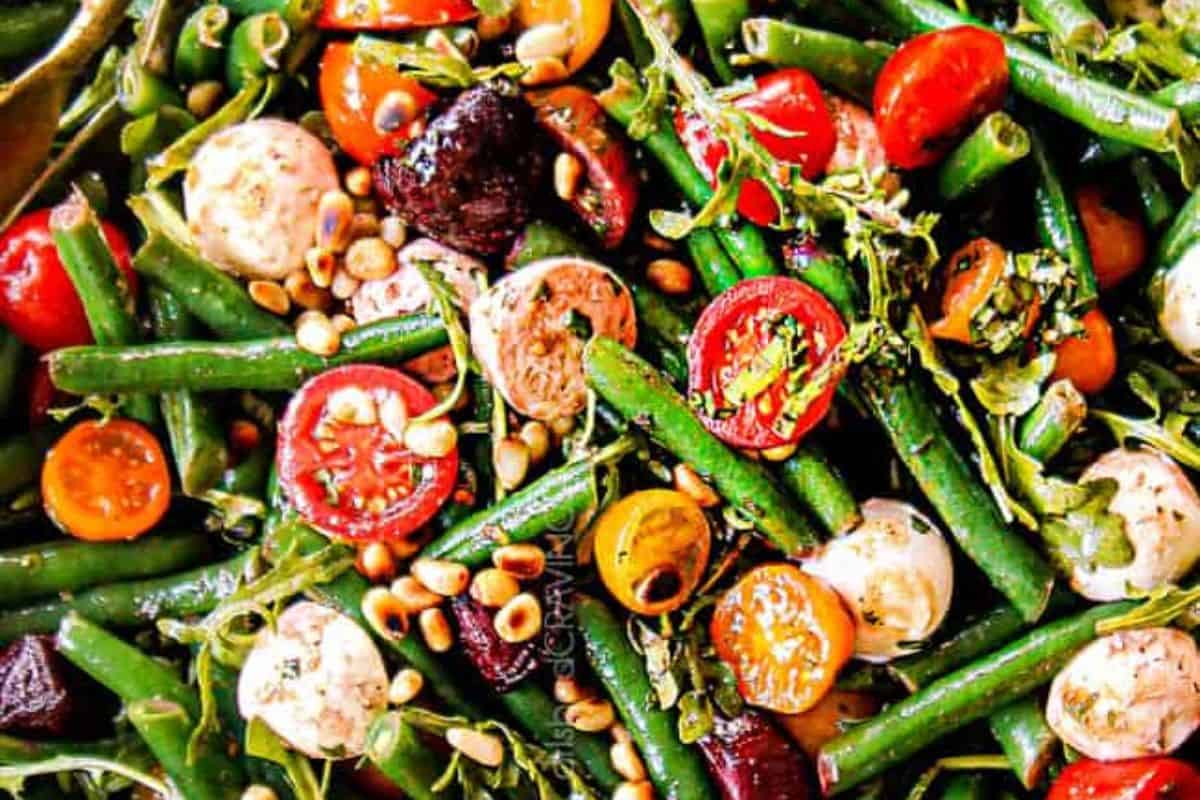 This vibrant salad bursts with color and flavor, featuring crisp green beans, juicy cherry tomatoes, mini mozzarella balls, and toasted pine nuts. Fresh herbs and a drizzle of balsamic vinaigrette tie it all together. It's a Mediterranean-inspired dish that looks as good as it tastes.