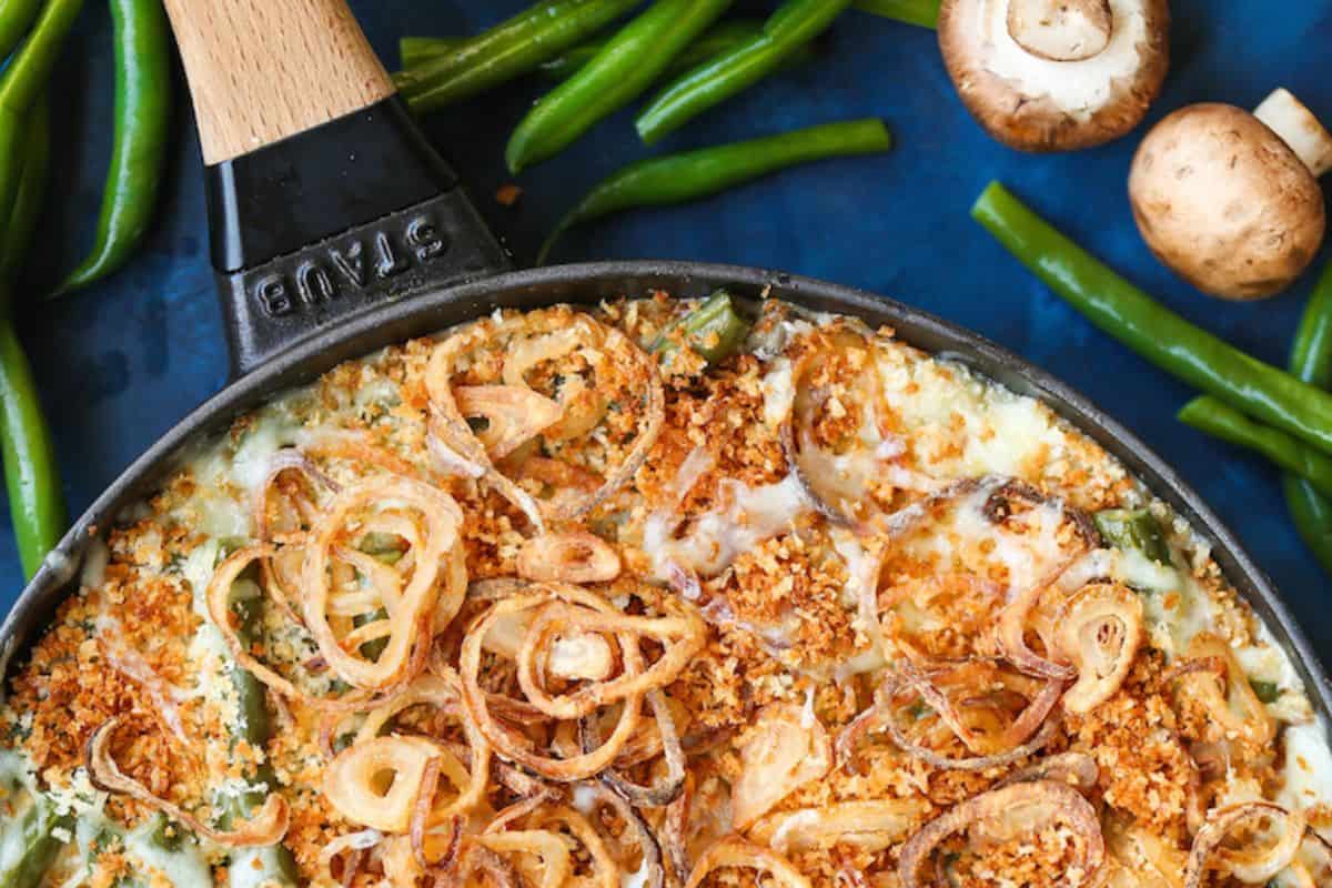 This upscale take on green bean casserole is topped with golden, homemade fried shallots and baked in a skillet. Underneath, tender green beans are coated in a creamy, savory sauce. It's a rich, comforting side dish that feels fancy without the fuss.