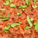 A close up of the meal with fresh herbs on top.