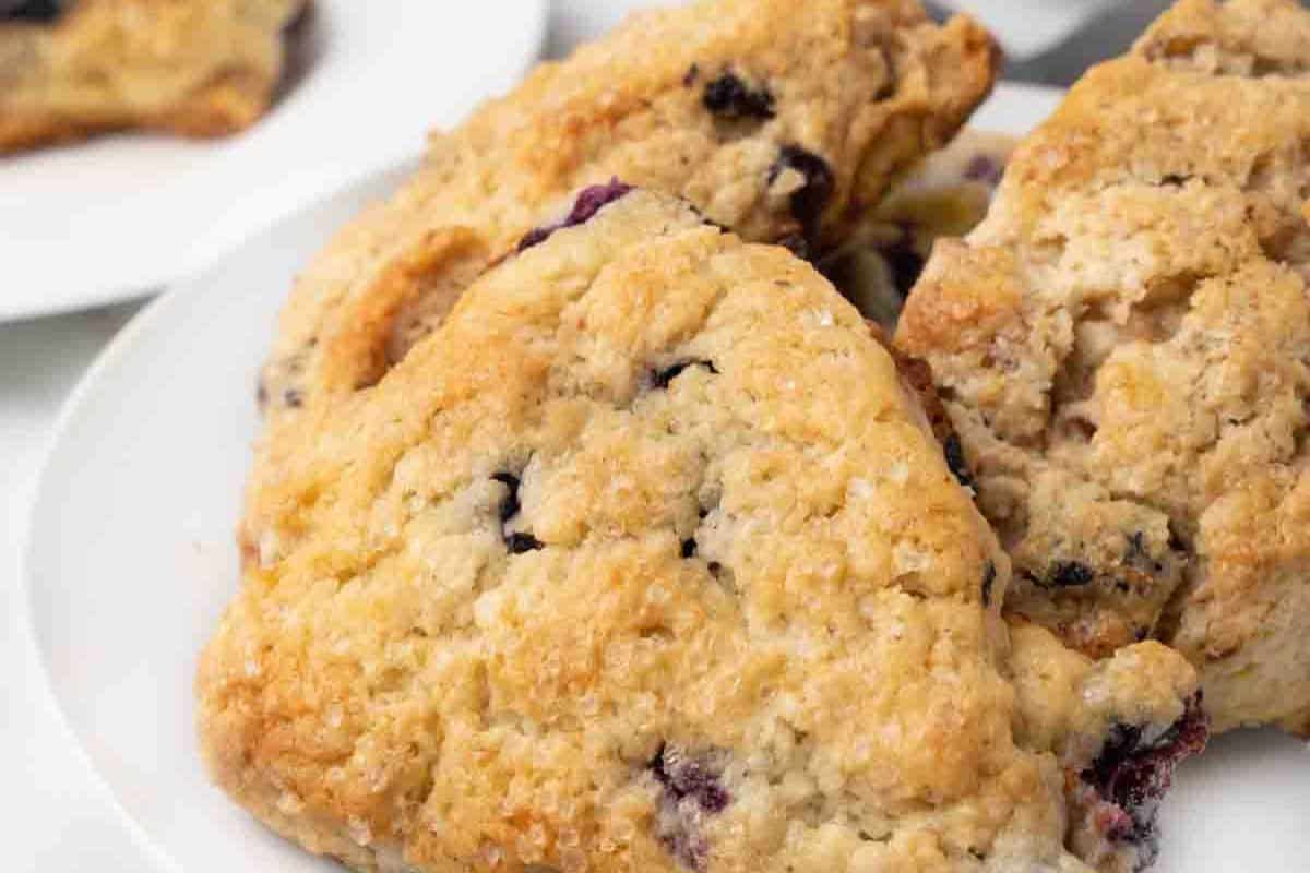 Close-up of blueberry scones, served on a white plate.