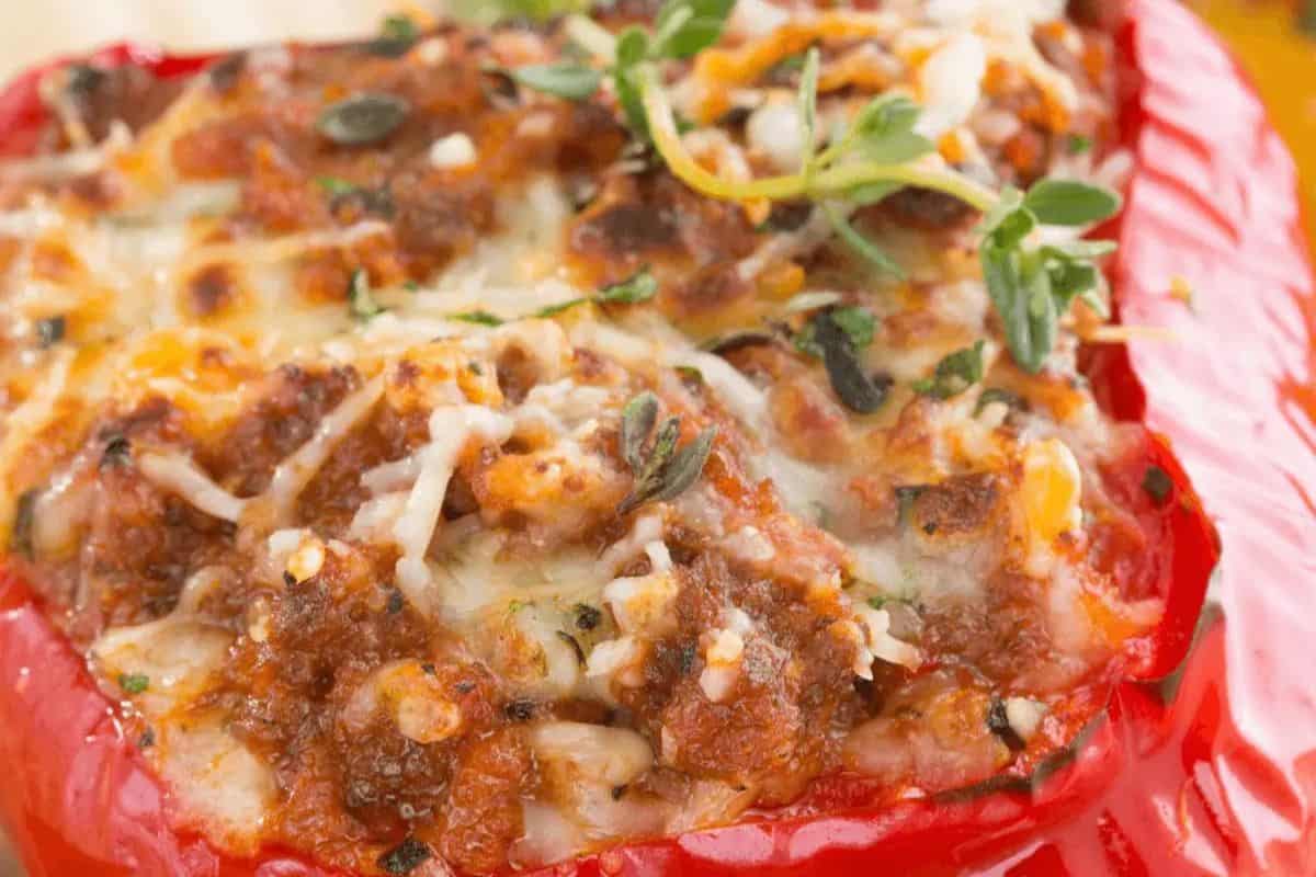 Close-up of a red bell pepper stuffed with chorizo, rice, and corn.