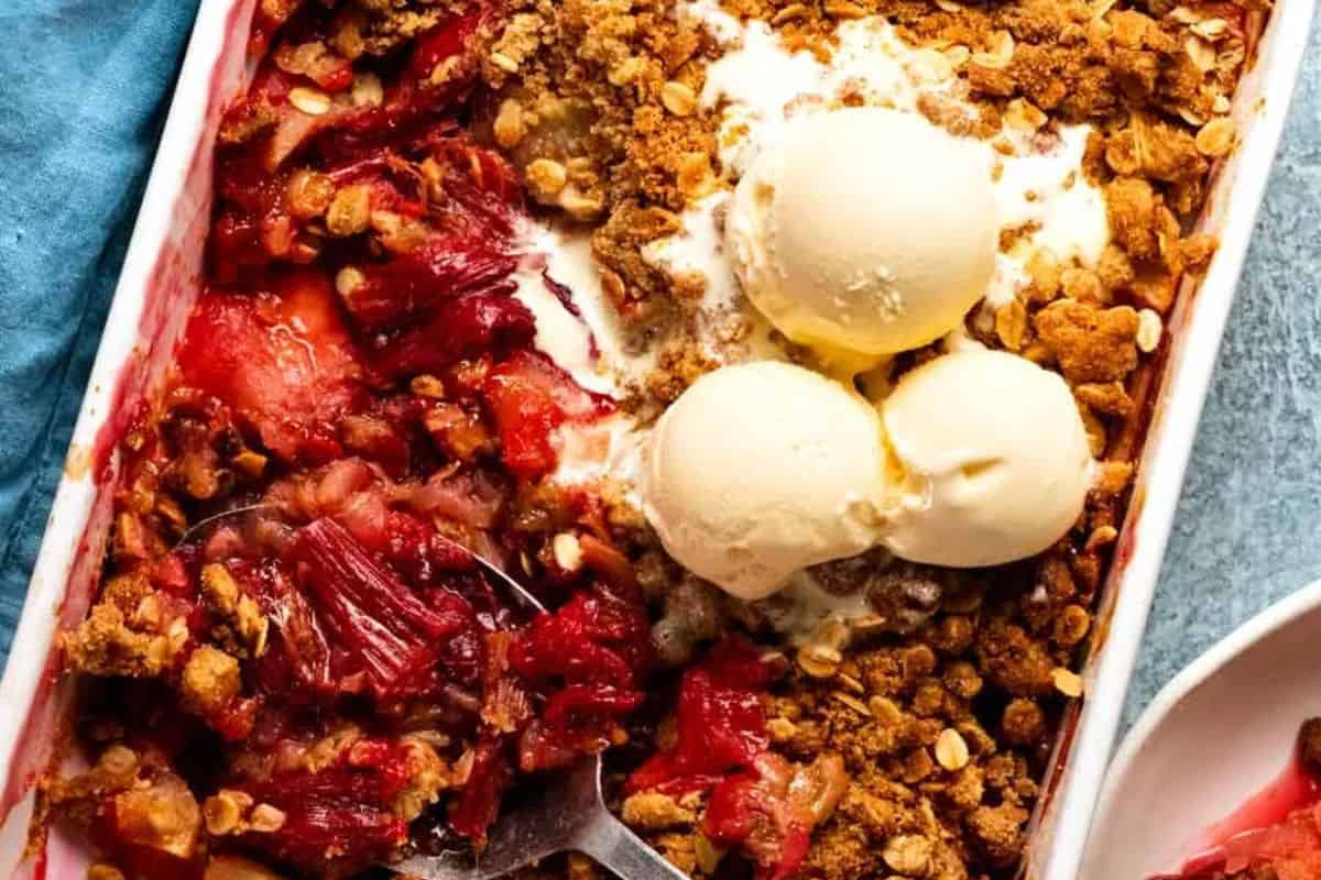 A rhubarb crumble with apple and topped with vanilla ice cream.