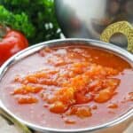 A bowl of stewed tomatoes.
