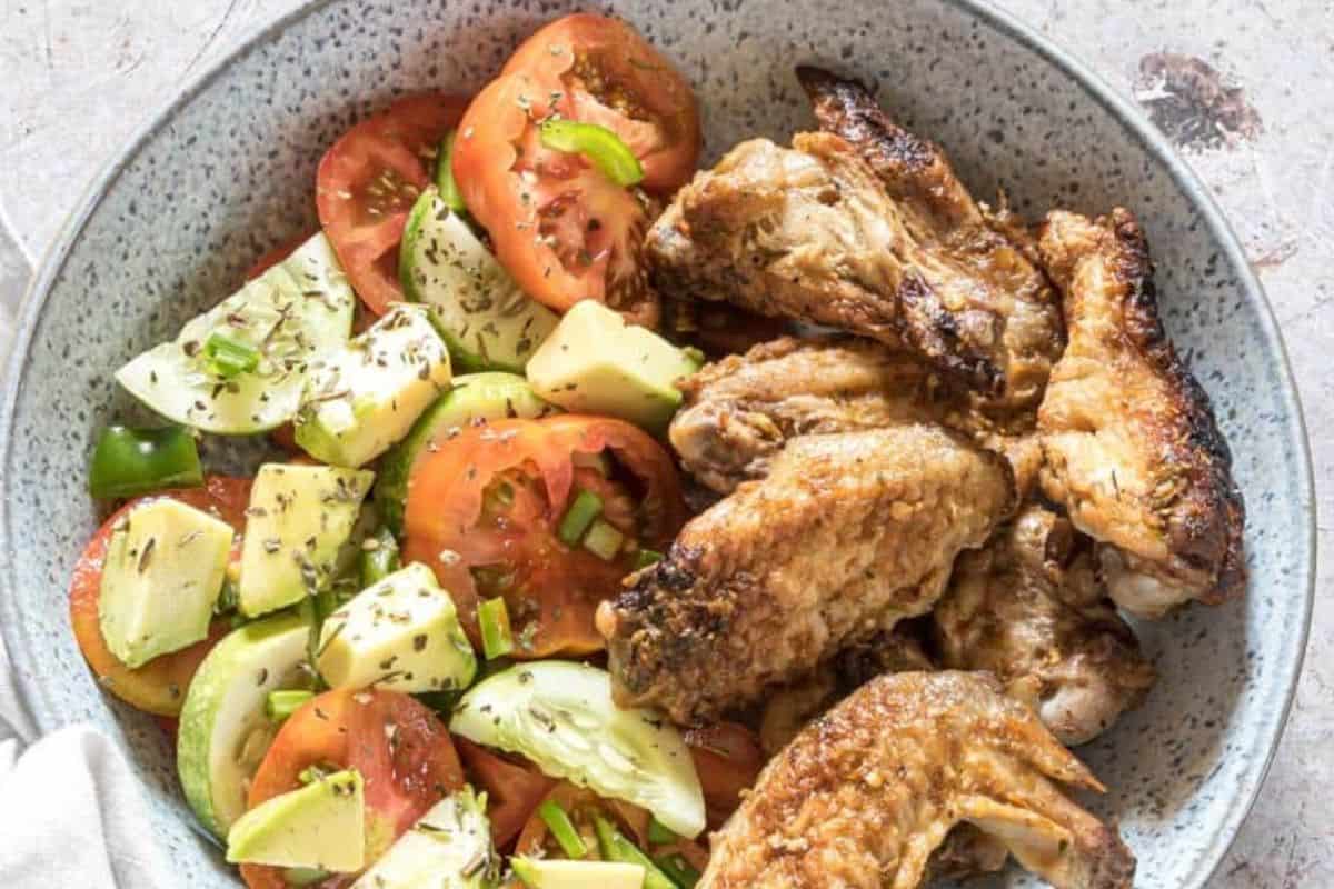 Smoked chicken wings with a deep reddish-brown smoky bark and a tender, juicy texture.