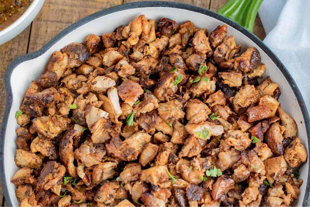 Copycat Chipotle chicken cooked in a pot, featuring grilled, marinated chicken pieces with a charred exterior and smoky seasoning.