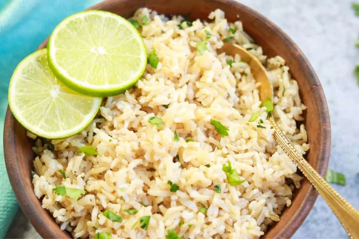 Fluffy white rice mixed with chopped cilantro and fresh lime zest, served in a bowl.