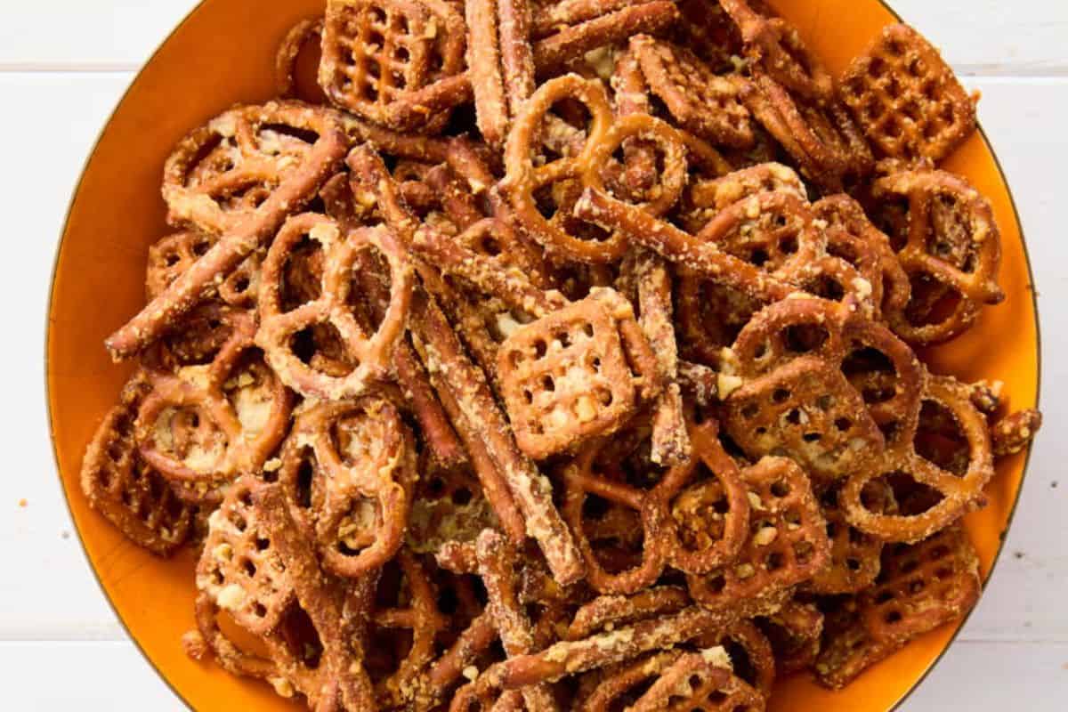 Crunchy pretzels coated in a savory garlic parmesan seasoning, served in a bowl.