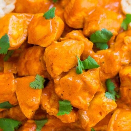 A close-up of chicken tikka masala served over rice, garnished with fresh cilantro leaves—this must-try dish showcases the bold flavors found in classic Indian recipes.