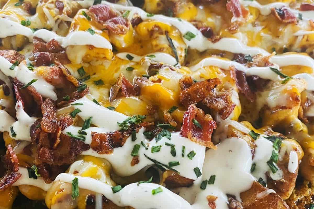 Loaded potatoes topped with crispy bacon, melted cheese, and creamy ranch dressing.