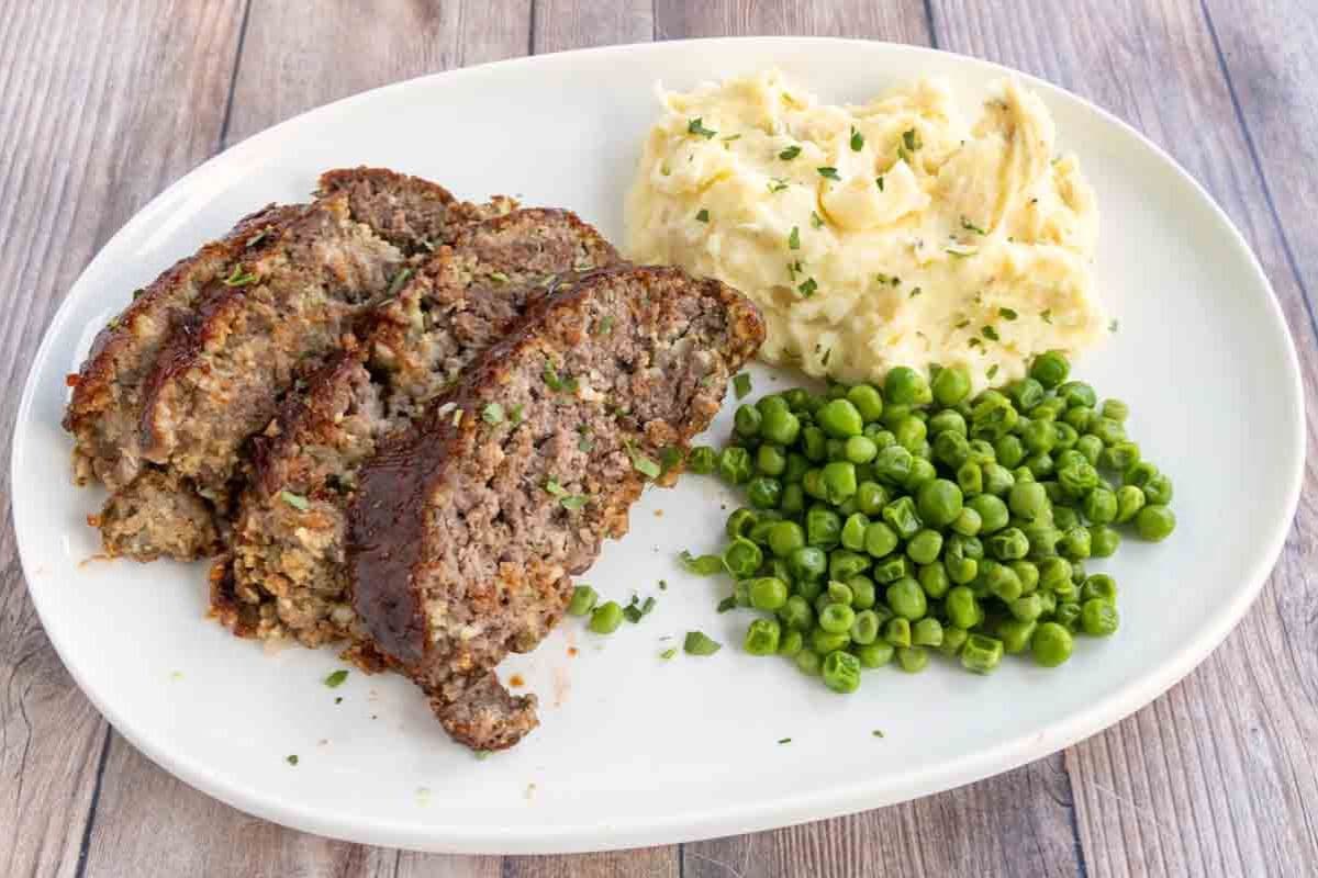 Slices of smoked meatloaf with a dark, smoky crust and moist, tender interior.