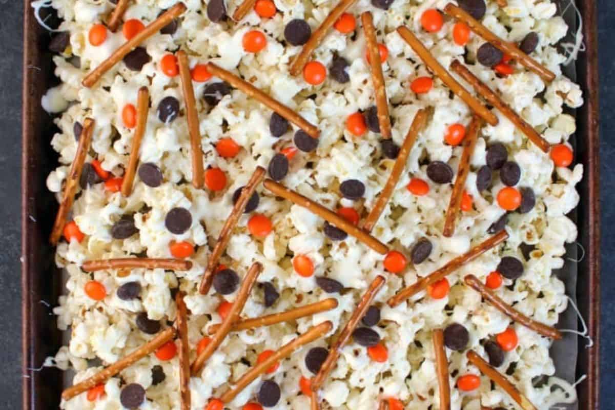 A popcorn mix with white chocolate, marshmallows, and candy eyes served on a tray.