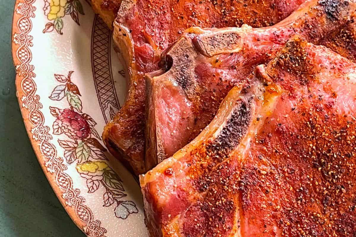 Smoked pork chops with a caramelized, smoky crust and tender, juicy meat inside.
