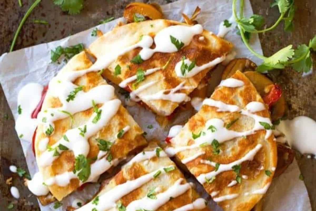 Golden-brown quesadillas filled with melted smoked gouda cheese and sautéed mushrooms, cut into triangles and served warm.