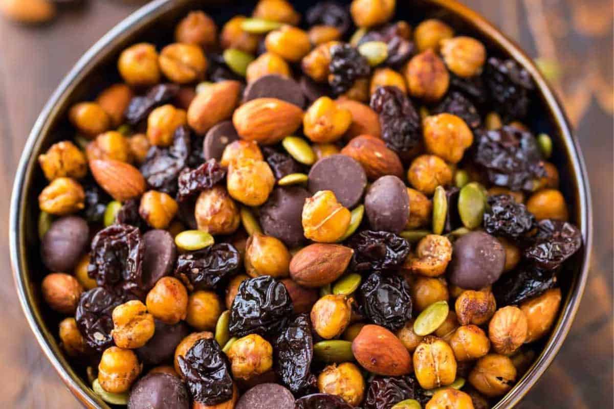 Roasted chickpea snack mix with crispy chickpeas, nuts, and seeds seasoned with savory spices, served in a bowl.