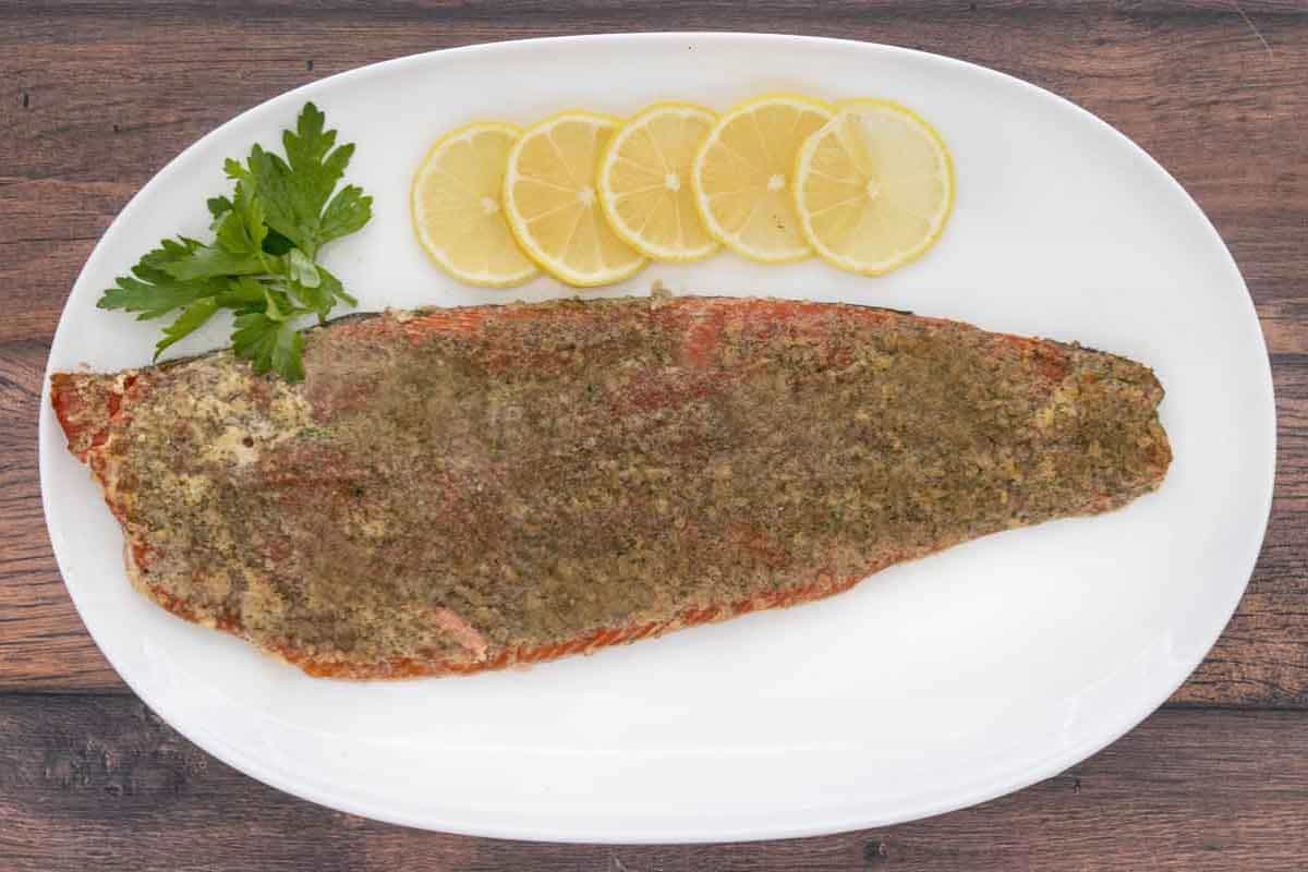 A slab of smoked salmon with a vibrant orange color and a glossy, tender surface.