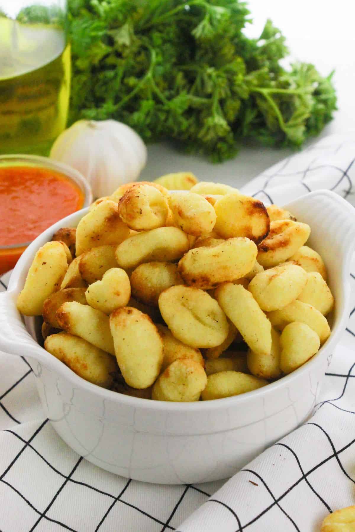 A white bowl of the air fryer gnocchi.