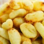 A close-up of a bowl filled with golden, crispy Air Fryer Gnocchi pieces.