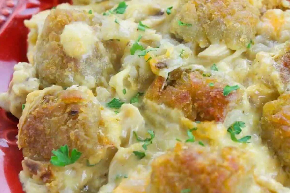 Close-up of tater tots in a creamy sauce, garnished with chopped parsley—a perfect addition to your easy dinner recipes for budget friendly dinners.