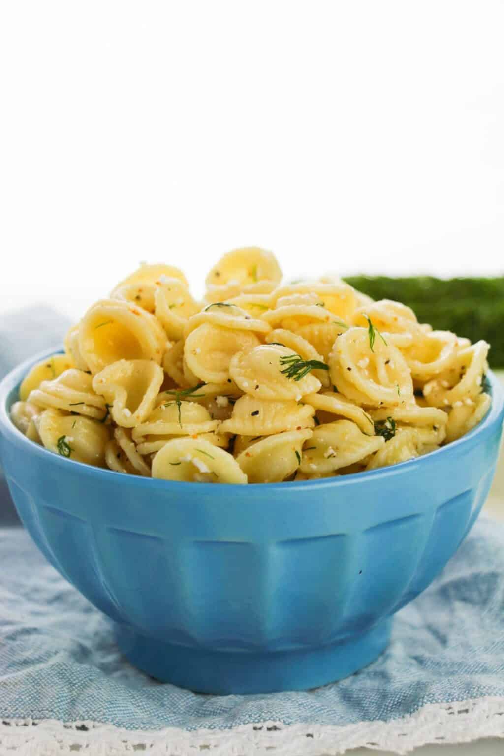 A blue dish of the dill pasta salad with feta cheese.