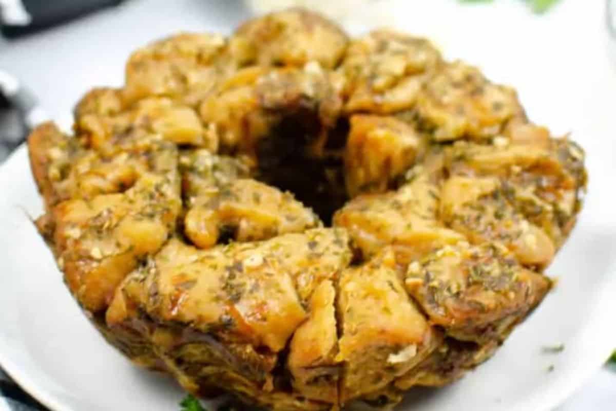 Close-up of some instant pot garlic parmesan monkey bread, serve on a white dish.