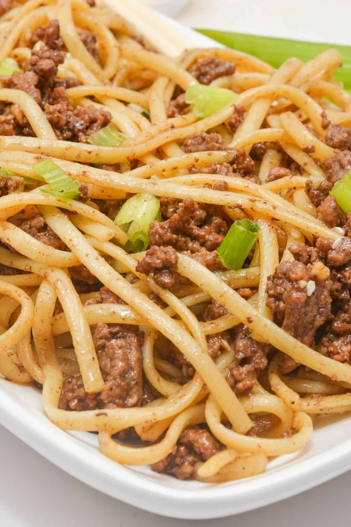 A plate of mongolian ground beef and noodles.