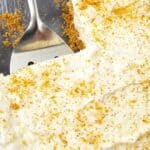 A pan of the no bake dish with whipped cream on top.