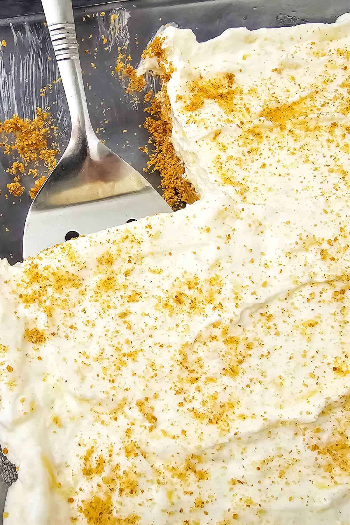 A pan of the no bake dish with whipped cream on top.